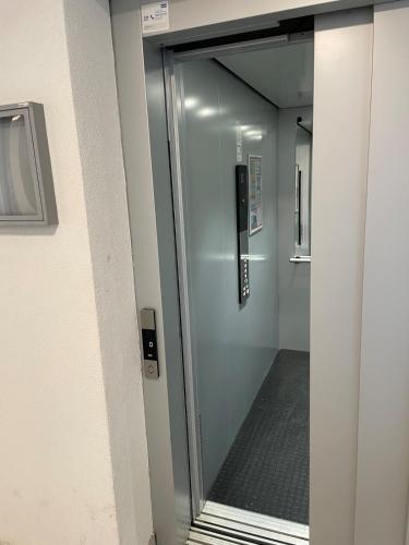 a glass door to a shower in a building at Sophia in Vranje