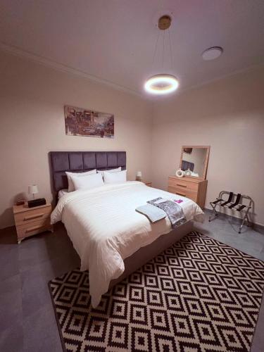a bedroom with a large bed and a rug at أوريانا Oriana in Jeddah