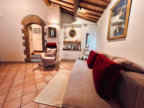 a living room with a couch and a chair at Adagio Umbro in Sustrico Di Spoleto