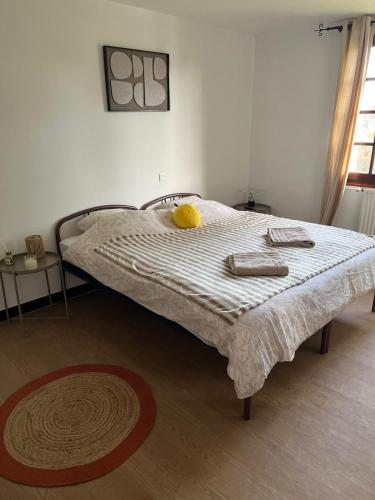 a bed with a yellow stuffed animal on top of it at Le Pavillon in Vendôme