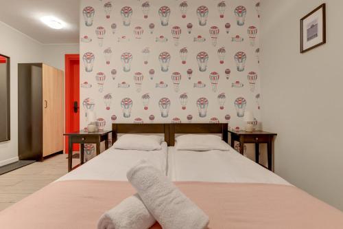 a bedroom with two beds and a wall with a wallpaper at WaterLane Island Hostel&Apartments in Gdańsk