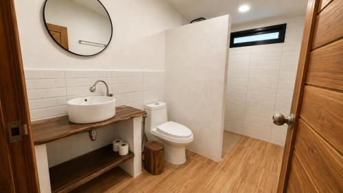 a bathroom with a sink and a toilet and a mirror at Sawan villa in Hinkong