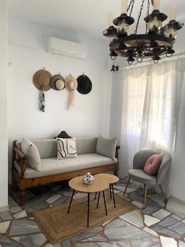 a living room with a couch and a table at Rokombo House Tinos in Tinos