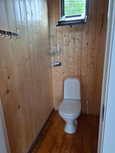 a bathroom with a toilet in a wooden wall at AnArt resort in Vanadzor