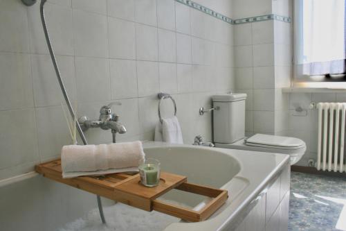 a bathroom with a bath tub with a candle on it at Villa Marina Como Boutique B&B & Apartments in Como