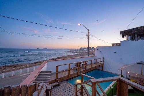 a balcony with a view of the ocean at El Templo Surf House in Punta Hermosa