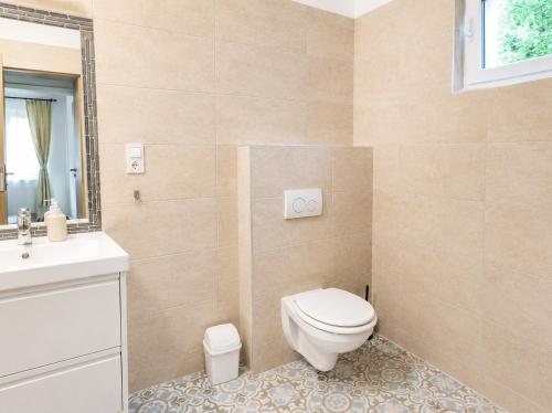 a bathroom with a toilet and a sink at Garden Home in Törökbálint