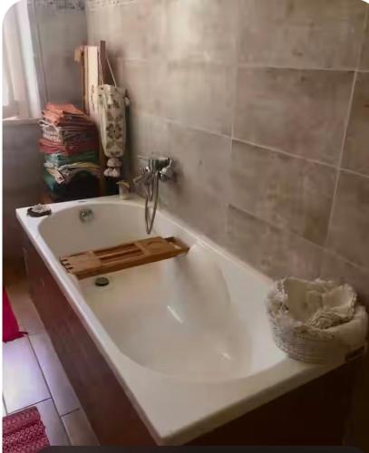 a bath tub with a faucet in a bathroom at Latte e Menta House in Casale
