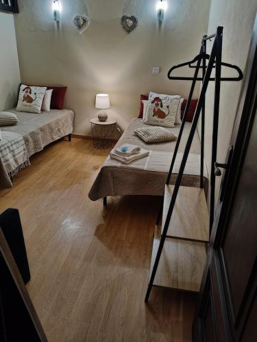 a small room with two beds and a ladder at Blue House in Ucanha