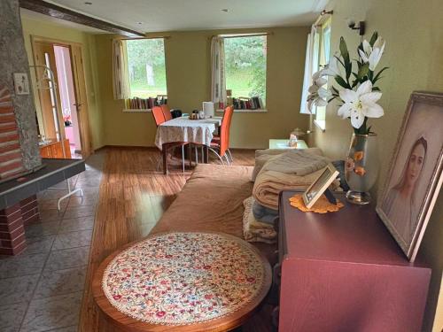 a living room with a couch and a table at Saules nams in Rucava