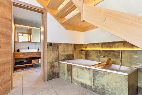 a bathroom with a tub and a sink at Tiny House in Pischelsdorf am Engelbach
