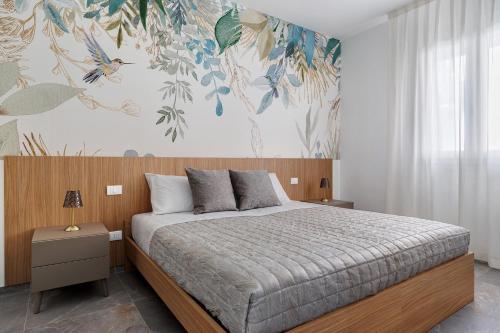 a bedroom with a bed with a floral wallpaper at La Rocca D'amuri - Alma e Aura in Partinico