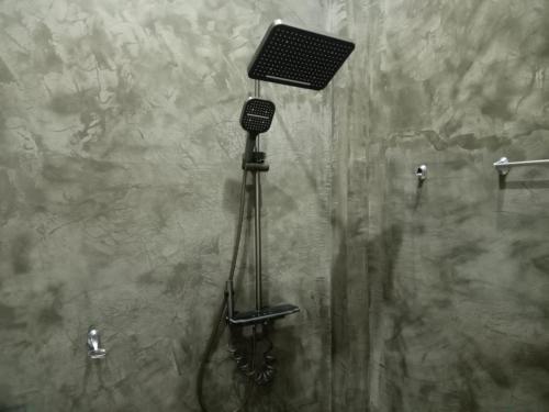 a shower with a shower head in a bathroom at Yara Eleven in Ambalangoda