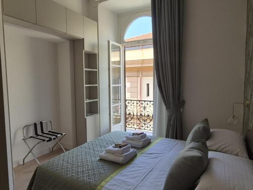 a bedroom with a bed with towels on it at Napoli Mariana Luxury in Naples