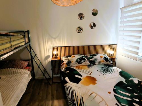 a bedroom with a bed with pillows on it at Le Havre des Dunes in Brem-sur-Mer