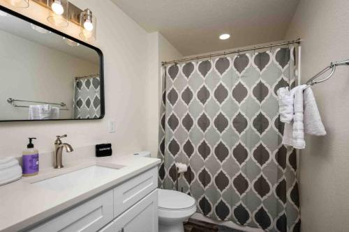 a bathroom with a toilet and a shower with a mirror at Wintergreen Unit 1 in Salem
