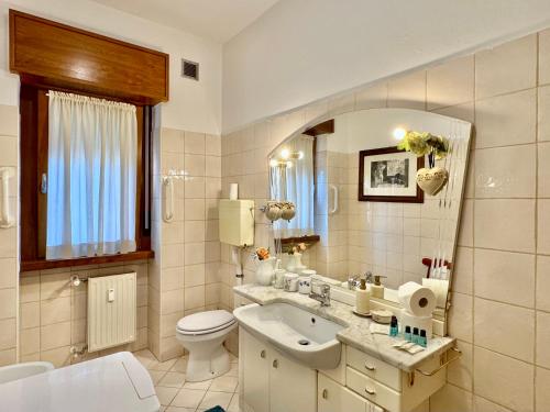 a bathroom with a sink and a toilet and a mirror at 1Dest - Garda Vintage in Arco