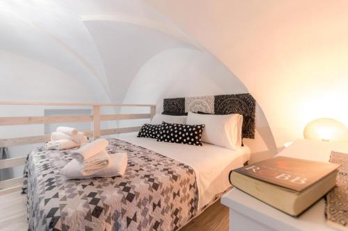 a bedroom with a bed with a book on it at Rondinelle by Palazzo Refolo in Martano