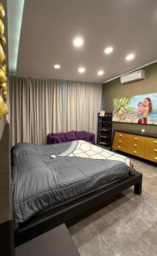 a bedroom with a bed and a flat screen tv at Villa with the red pool in Hinkong