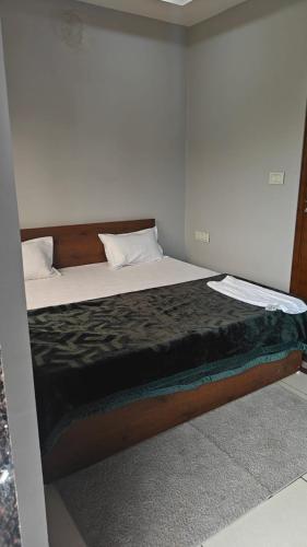 a bedroom with a large bed with at Hotel Trilok in Ujjain