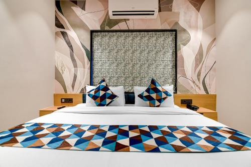a bedroom with a large white bed with colorful pillows at Morya Villa - A Boutique Hotel in kolkata