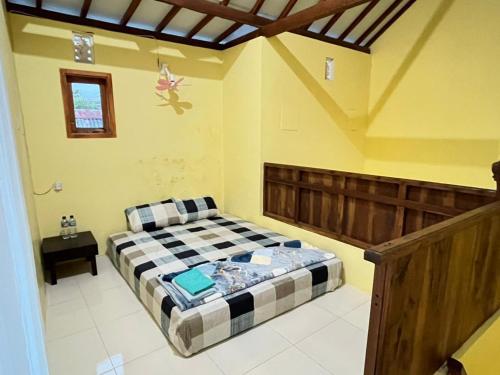 a bedroom with a bed in a room at Homestay RnJ in Licin