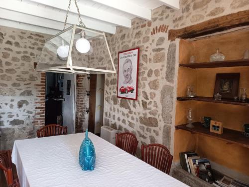 a blue vase sitting on a table in a room at Les Vergnes in Saint-Pardoux-le-Neuf