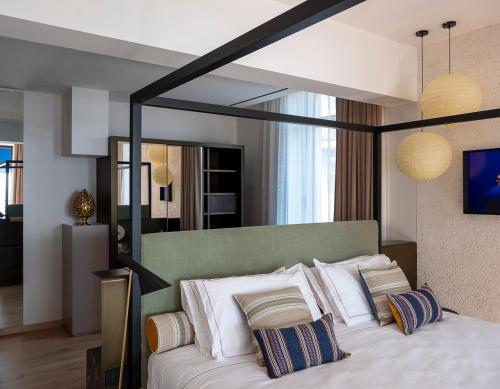 a bedroom with a large bed with white pillows at Park Hotel in Desenzano del Garda