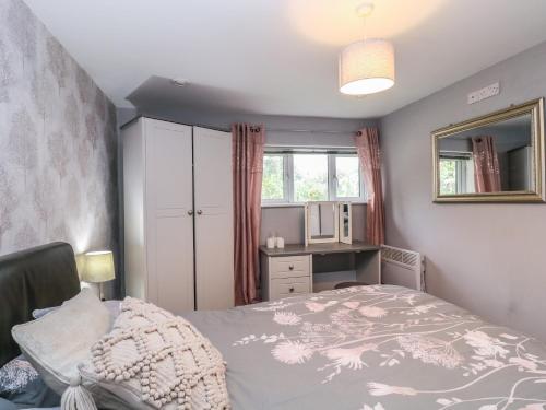 a small bedroom with a bed and a window at Little Herriotts in Bristol