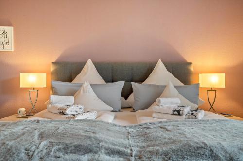 a bedroom with a large bed with white pillows at Baden-Chalet - Wandergenuss in Bühl