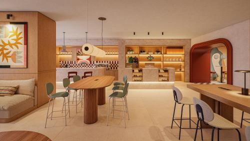a living room with a table and chairs at INNSiDE by Meliá Mexico Roma Norte in Mexico City