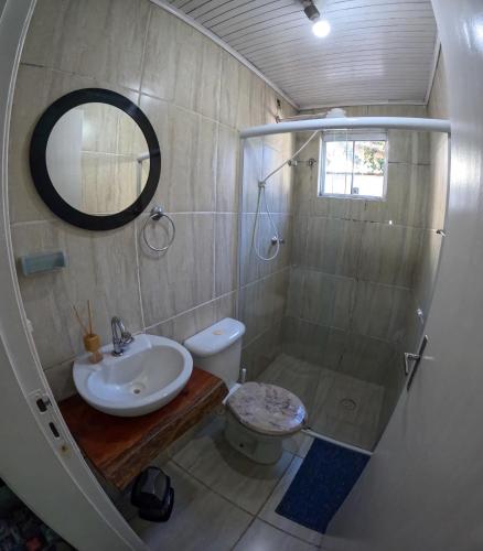 a bathroom with a shower and a sink and a toilet at Chale Maresias 1 in São Sebastião