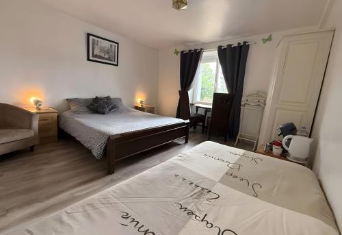 a bedroom with a bed with a cat sitting on it at Chambre d'hotes 3 et 4 a la ferme in Champsac