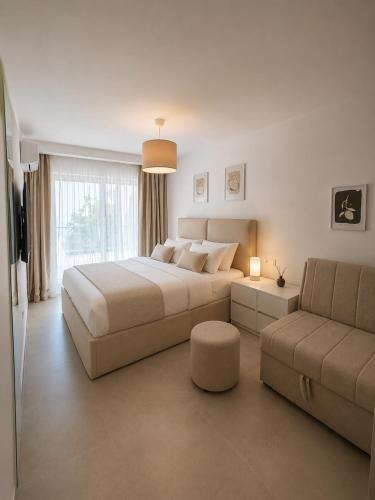 a bedroom with a large bed and a couch at White Arches in Ulcinj