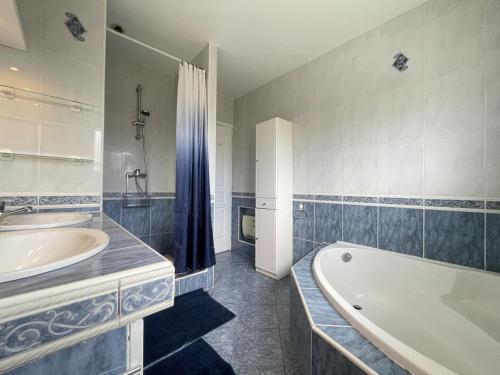 a white bathroom with a tub and a sink at Uhalden borda in Saint-Jean-de-Luz