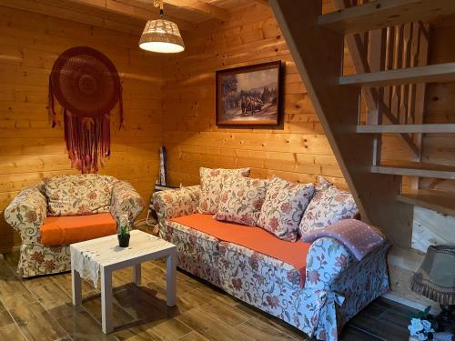 a living room with a couch and a table at Nela Martiany in Martiany