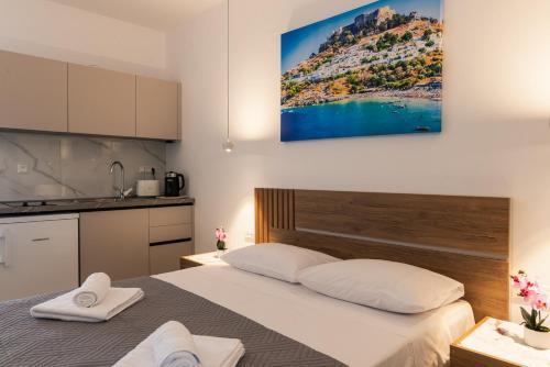 a bedroom with a bed with two towels on it at Aimilia Boutique Studio Kalathos in Kalathos