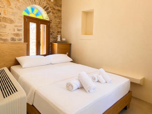 two beds in a room with towels on them at Luxe Lane Kalamoti in Chios