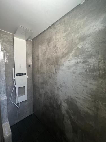 a bathroom with a wall with a painting on it at Iconic Project Lagada in Amorgos