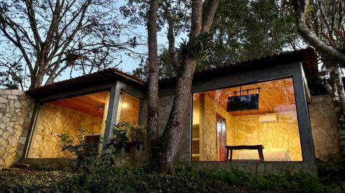 a small house with a chair in front of it at Exclusive Huts in Gravatá