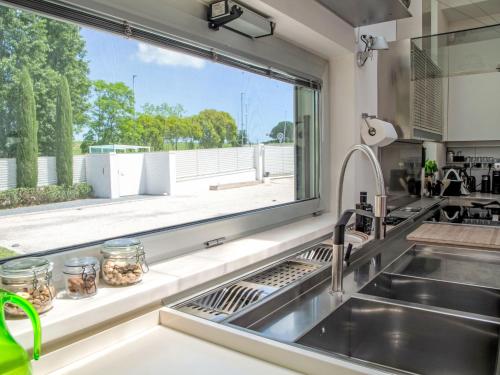 a kitchen with a sink and a large window at Villa Mulberry Garden by Interhome in San Marcello