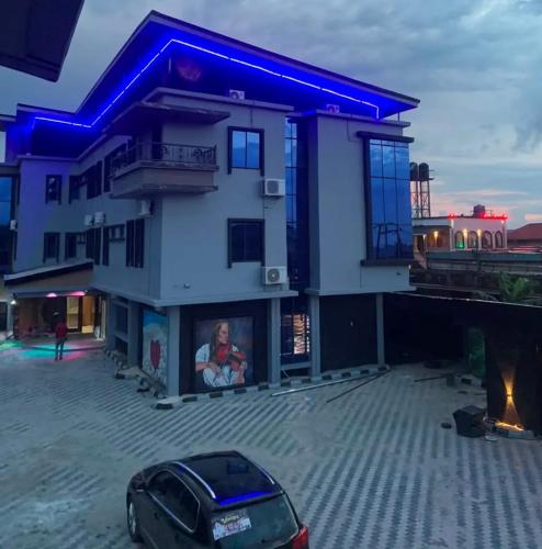 a building with a car parked in front of it at Eraton Hotel in Warri