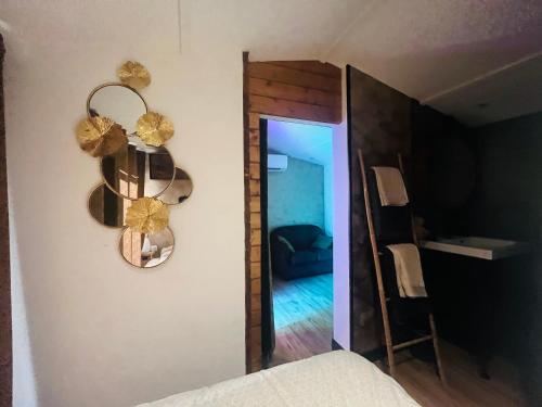 a bedroom with a mirror on the wall and a staircase at Chalet cosy atypique avec petite piscine in Vichy