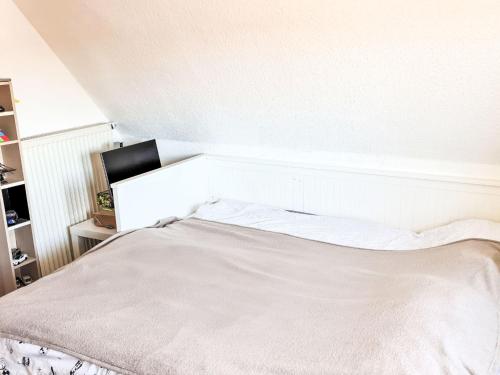 a white bed in a bedroom with a white wall at Apartment Workbase Nidderau by Interhome in Nidderau