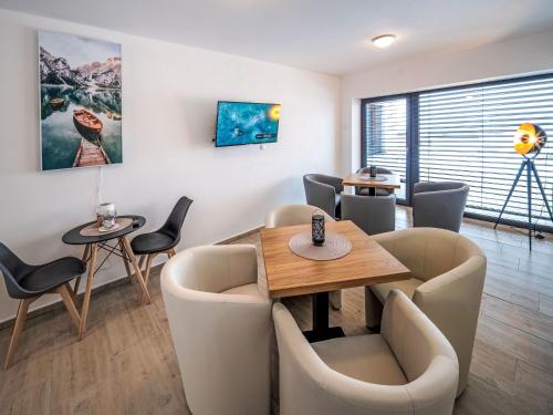 a waiting room with a table and chairs at Studio V Šachu-3 by Interhome in Dačice