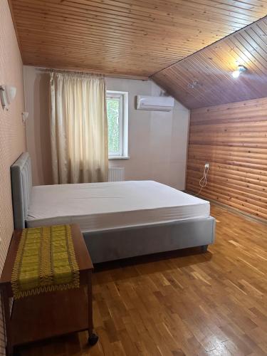 a bedroom with a large bed and a wooden ceiling at Casa Centru Chișinău in Chişinău