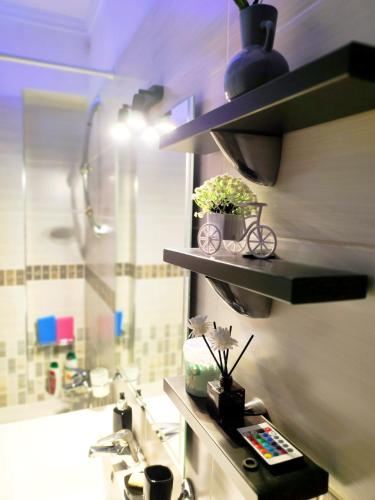 a bathroom with a sink and a shower and a counter with a sink at CS apartment Patra in Patra