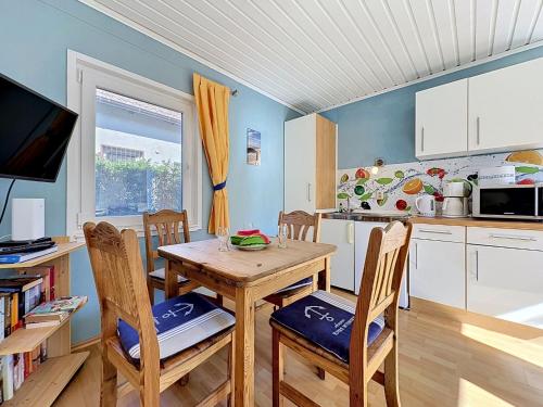 a kitchen with a table and chairs in a kitchen at Apartment Gabi-2 by Interhome in Wiek auf Rügen
