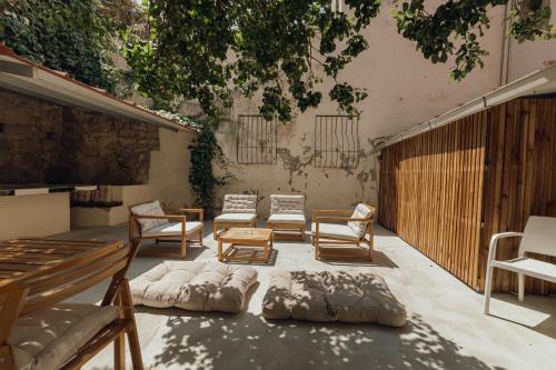a patio with a bunch of beds and chairs at Dear Porto By Hosty in Porto
