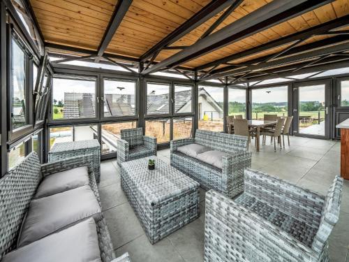 a living room with couches and a table and windows at Studio V Šachu-2 by Interhome in Dačice